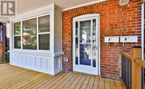 Toronto (The Beaches) apartment for rent - A white door with a glass window is on a brick wall.