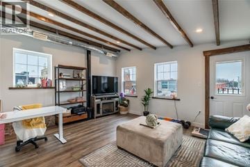 Chatham apartment for rent - A living room with a white couch and a television.