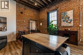 Chatham apartment for rent - A room with a wooden table and chairs with a brick wall.