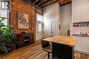 Chatham apartment for rent - A kitchen with a wooden table and a brick wall.