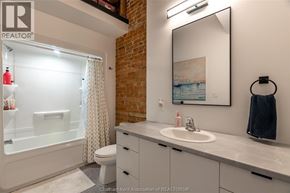 Chatham apartment for rent - A bathroom with a toilet, sink, and a mirror.