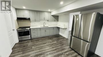 Kitchener apartment for rent - A modern kitchen with a stainless steel refrigerator and wooden flooring.