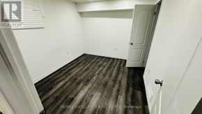 Kitchener apartment for rent - A room with wooden flooring and white walls.