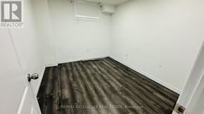 Kitchener apartment for rent - A room with wooden flooring and white walls.