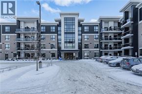 Guelph condo for rent - A snowy scene with apartment buildings and a REALTOR sign.