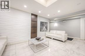 Guelph condo for rent - A modern living room with a white sofa and a glass coffee table.