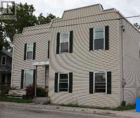 Oshawa (Lakeview) multi-family for rent - A two-story house with a white siding and black shutters.