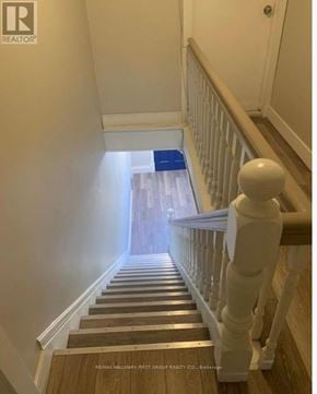 Oshawa (Lakeview) multi-family for rent - A staircase with a blue mat on the bottom step.