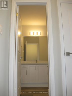 Niagara Falls (Morrison) townhouse for rent - A bathroom with a sink, mirror and cabinets.