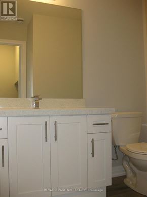 Niagara Falls (Morrison) townhouse for rent - A white bathroom with a toilet and a vanity.