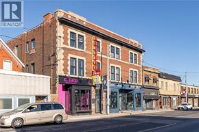 Hamilton apartment for rent - A street view with a building that has a sign that says "L.A. TITIES".