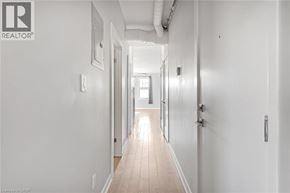 Hamilton apartment for rent - A long hallway with doors on both sides and a light at the end.