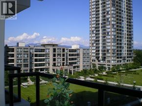 Burnaby apartment for rent - A balcony overlooks a grassy area and apartment buildings.