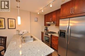 Burnaby apartment for rent - A kitchen with a granite countertop and stainless steel appliances.
