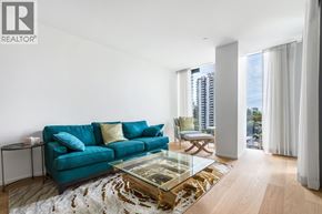 Vancouver apartment for rent - A living room with a blue couch and a glass coffee table.