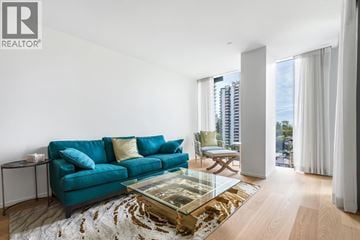 Vancouver apartment for rent - A living room with a blue couch and a glass coffee table.