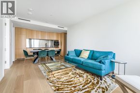 Vancouver apartment for rent - A living room with a blue couch and a glass coffee table.