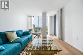 Vancouver apartment for rent - A living room with a blue couch and a glass coffee table.