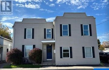 Oshawa (Lakeview) multi-family for rent - A two-story house with a blue door and windows.