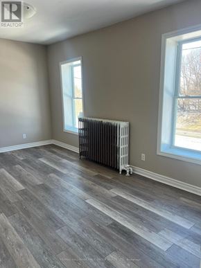 Oshawa (Lakeview) multi-family for rent - A room with a grey floor and a window with a white frame.
