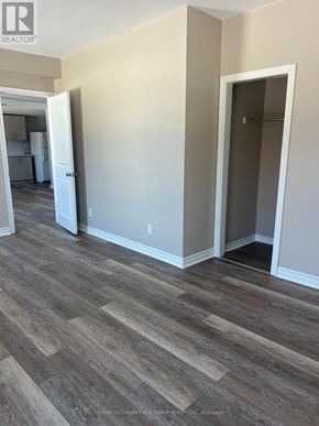Oshawa (Lakeview) multi-family for rent - A room with wood flooring and a doorway leading to another room.