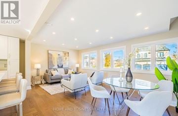 Mississauga (Lakeview) apartment for rent - A well-lit, modern living room with a glass table and white chairs.