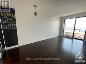 Ottawa condo for rent - A room with a blackboard and a window overlooking a balcony.