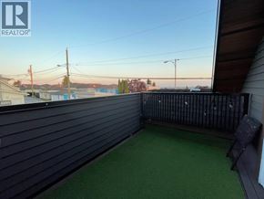 Vancouver apartment for rent - A balcony with a black railing and a green carpet.