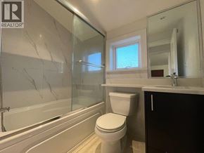 Vancouver apartment for rent - A bathroom with a toilet, sink, and bathtub.