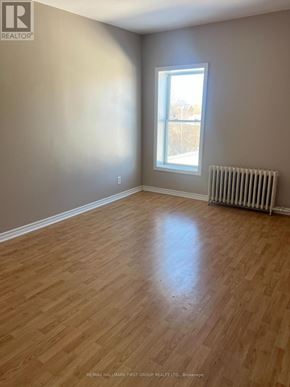 Oshawa (Lakeview) multi-family for rent - A room with a window and a radiator on the floor.