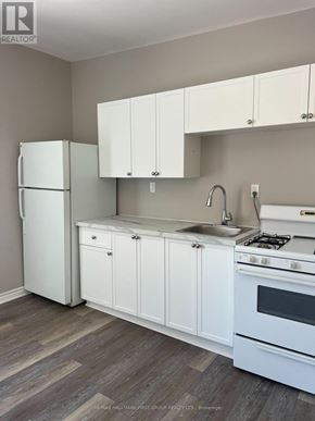 Oshawa (Lakeview) multi-family for rent - A kitchen with white appliances and cabinets.