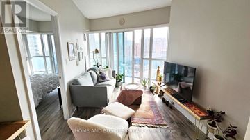 Mississauga (City Centre) condo for rent - A living room with a grey couch and a television.