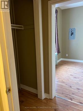Oshawa (Lakeview) multi-family for rent - A hallway with wood floors and a white door.