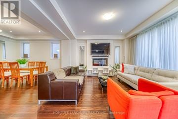 Toronto (Alderwood) apartment for rent - A living room with a white couch and a brown leather chair.