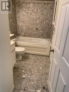 Toronto (Church-Yonge Corridor) condo for rent - A bathroom with a toilet, tub and tiled floor.