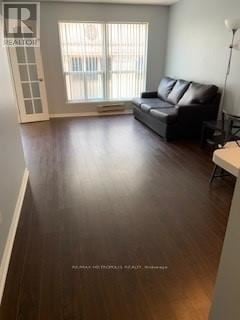 Toronto (Church-Yonge Corridor) condo for rent - A living room with a black couch and wooden floors.