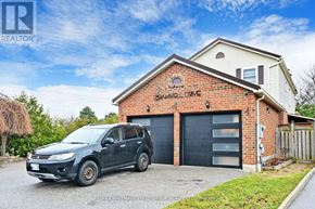 Ajax (Central West) apartment for rent - A house with a garage and a car parked in front.
