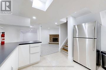 Ajax (Central West) apartment for rent - A modern kitchen with white cabinets and a stainless steel refrigerator.