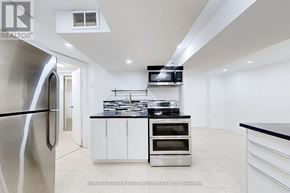 Ajax (Central West) apartment for rent - A modern kitchen with stainless steel appliances and white cabinetry.