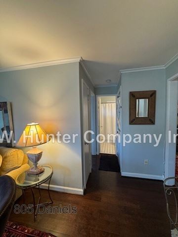 Raleigh apartment for rent - A living room with a lamp and a sofa.