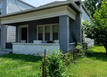 Louisville apartment for rent - A house with a white porch and a black fence.