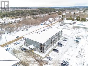 Bonnechere Valley multi-family for rent - A large building with a parking lot in front of it.