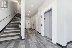 Bonnechere Valley multi-family for rent - A hallway with a staircase on the left and a door on the right.