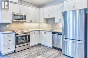 Peterborough (Ashburnham Ward 4) condo for rent - A kitchen with white cabinets and stainless steel appliances.