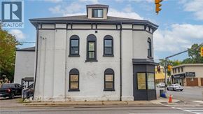 Brantford apartment for rent - A white building with a black roof and a sign that says REALTOR.