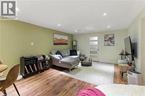Hamilton apartment for rent - A bedroom with a bed, a chair, and a painting on the wall.