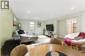 Hamilton apartment for rent - A living room with a couch, chair, and television.