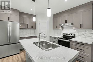 Russell apartment for rent - A modern kitchen with a stainless steel sink and refrigerator.