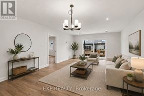 Russell apartment for rent - A well-lit, spacious living room with a large couch, a coffee table, and a chandelier.