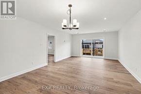 Russell apartment for rent - A large empty room with wooden floors and a chandelier.